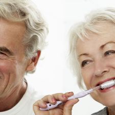 older couple brushing their teeth