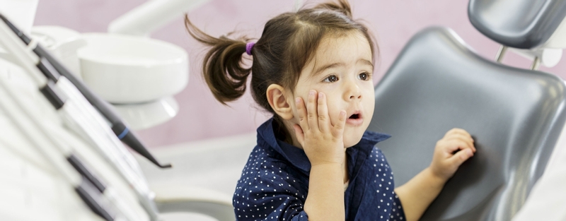 Little girl sitting in a dental chair