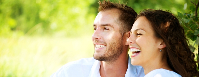 Smiling couple sitting in the grass