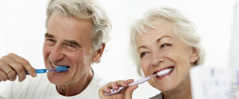 older couple brushing their teeth