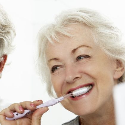 older couple brushing their teeth