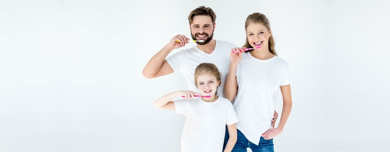 Family brushing their teeth together
