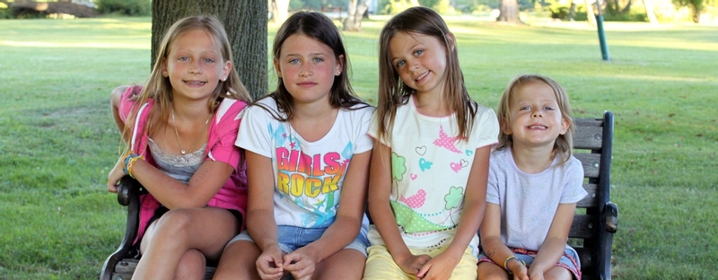 Children sitting under a tree