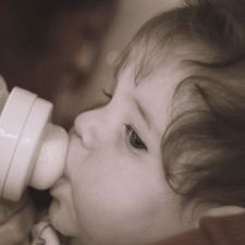 Baby nursing with a bottle