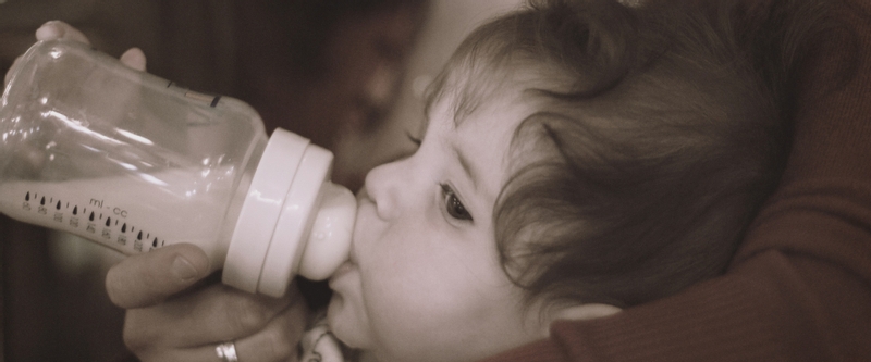 Baby nursing with a bottle