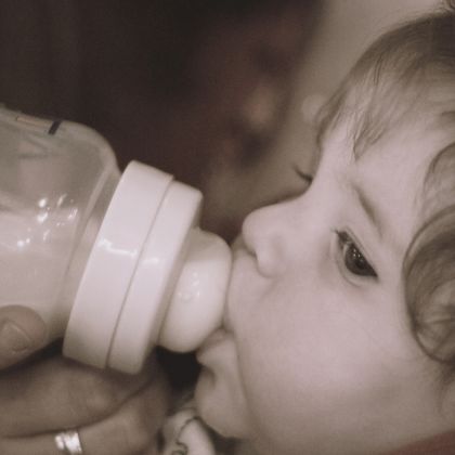 Baby nursing with a bottle