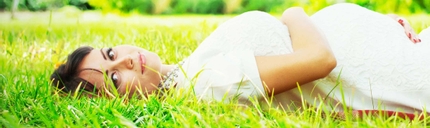 Pregnant woman lying in the grass